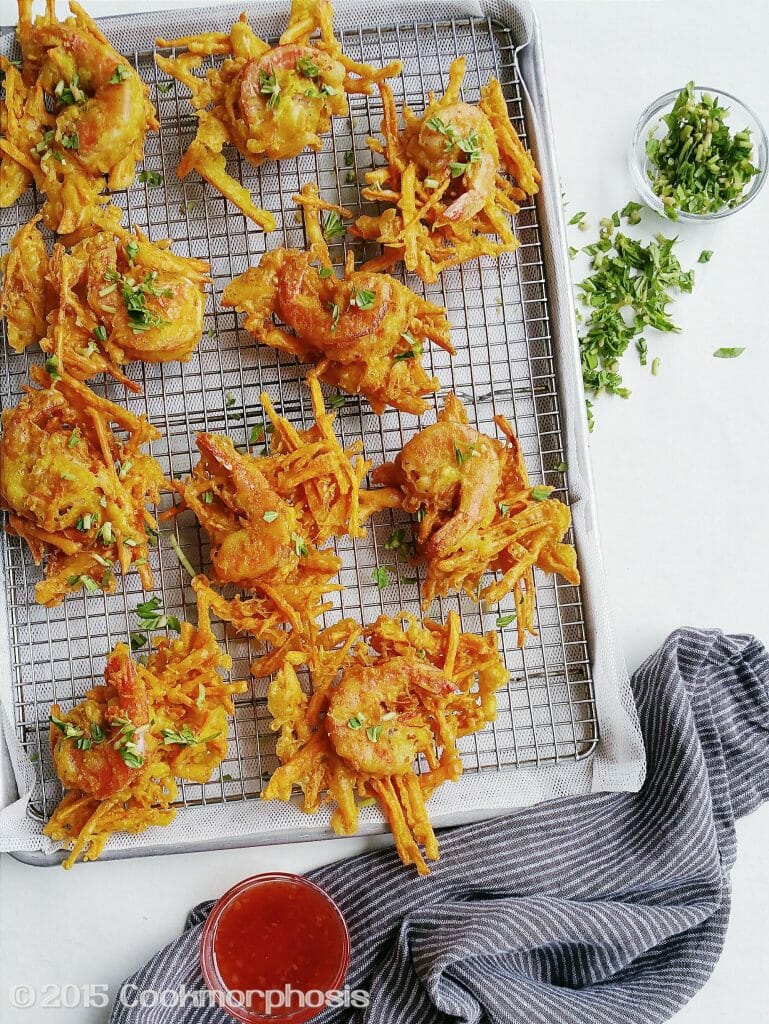 a tray of shrimp fritters with sweet chili sauce