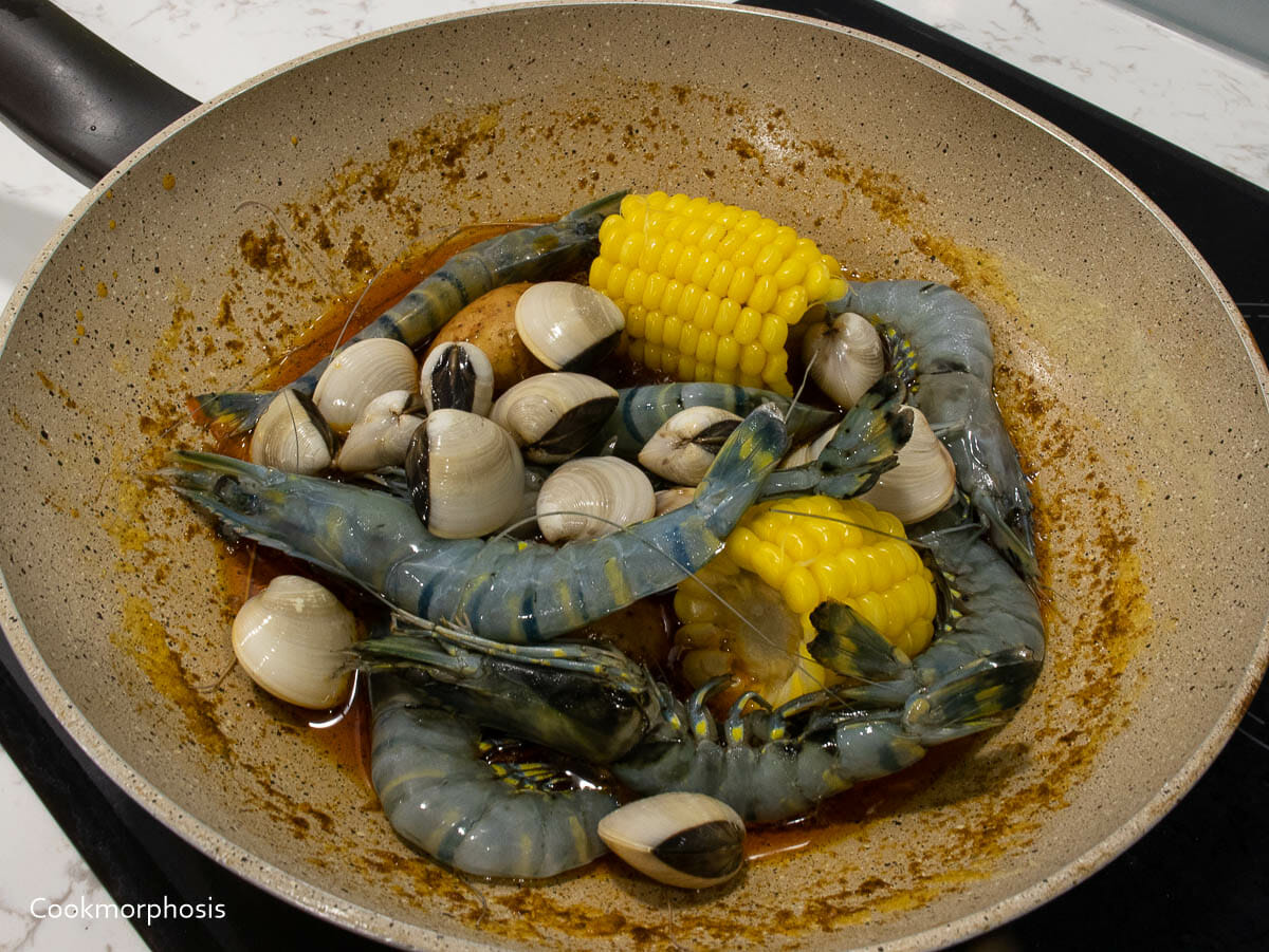 add uncooked shrimps, clams, or other seafood in to cajun seasoning mixture