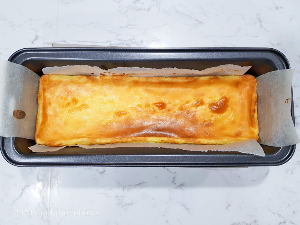 cheesecake in baking pan lined with parchment paper