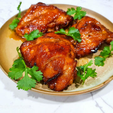 grilled sriracha char siu chicken thighs garnished with cilantro