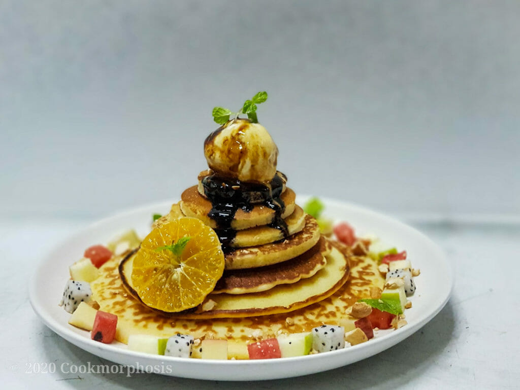 best homemade pancakes tower with fresh fruit, ice cream and syrup