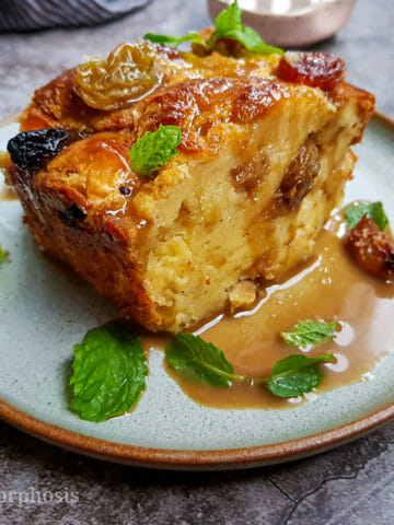 raisin bread pudding with coffee sauce and mint leaves as garnish