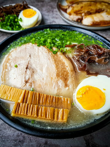 the best tonkotsu ramen topped with soft boiled egg, seasoned bamboo, wood ear mushroom, green onion