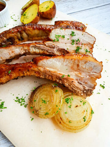 franklin barbeque style ribs pictured next to roasted white onion