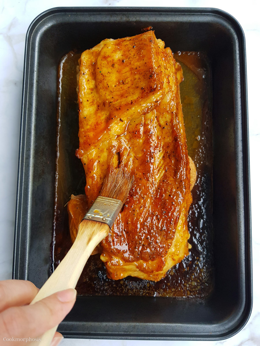 oven baked barbeque pork ribs brushed with barbecue sauce