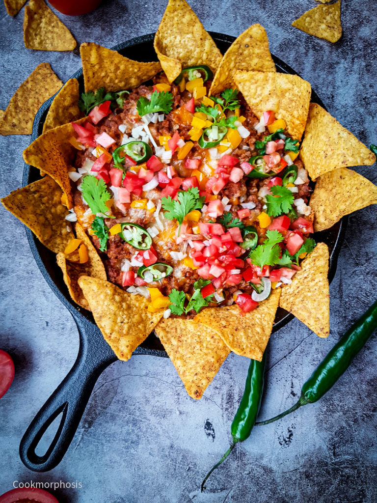 easy cheesy beef nachos served with tostitos chips, ground beef, cilantro, jalapeno, chopped tomato