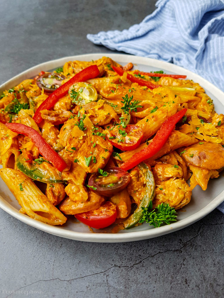 tasty cajun chicken penne pasta cooked with smoked sausages, bell pepper, cherry tomatoes and garnished with parsley