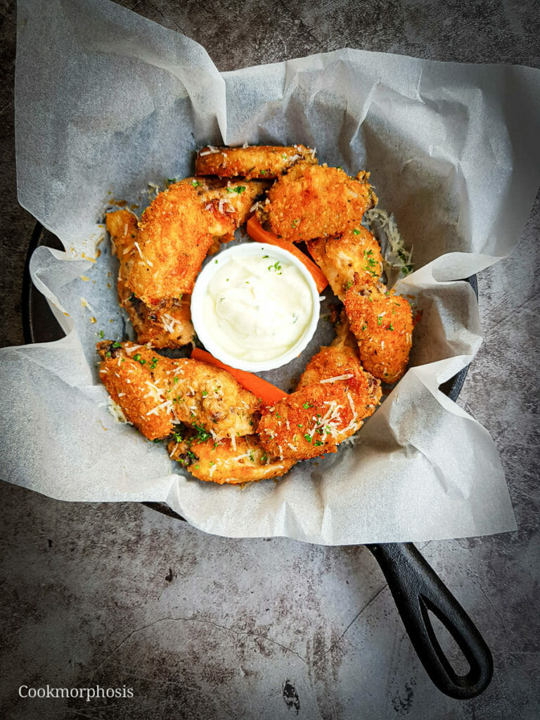 Baked parmesan chicken wings served with ranch and carrot sticks