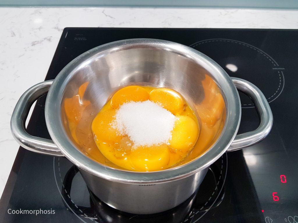 Combine egg yolks and sugar on the top of double boiler to cook custard
