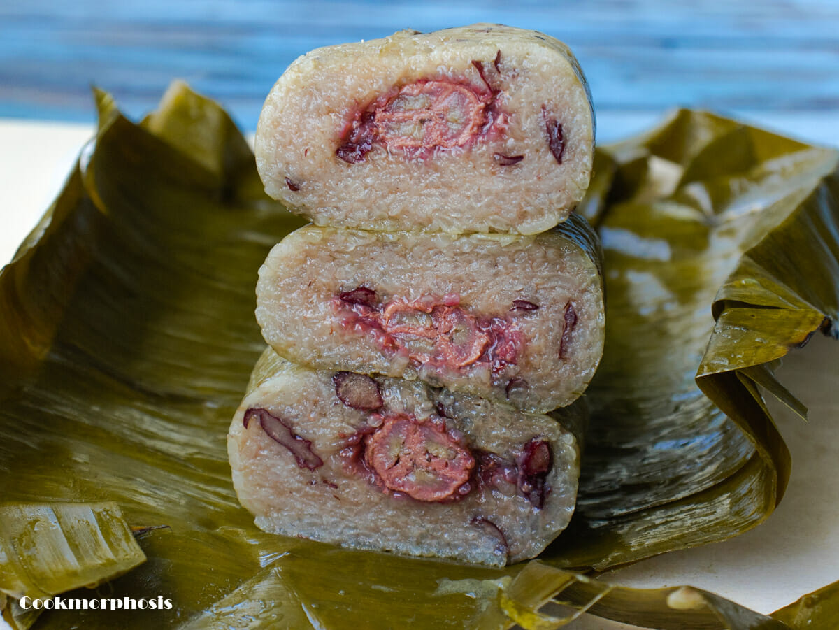 glutinous rice banana cakes cut into slices and stacked over banana leaves