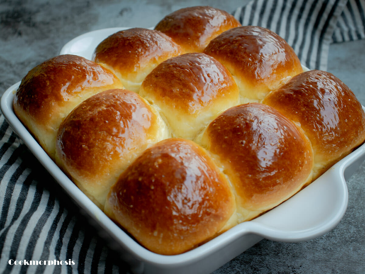 fluffy milk dinner rolls are topped with condensed milk glaze
