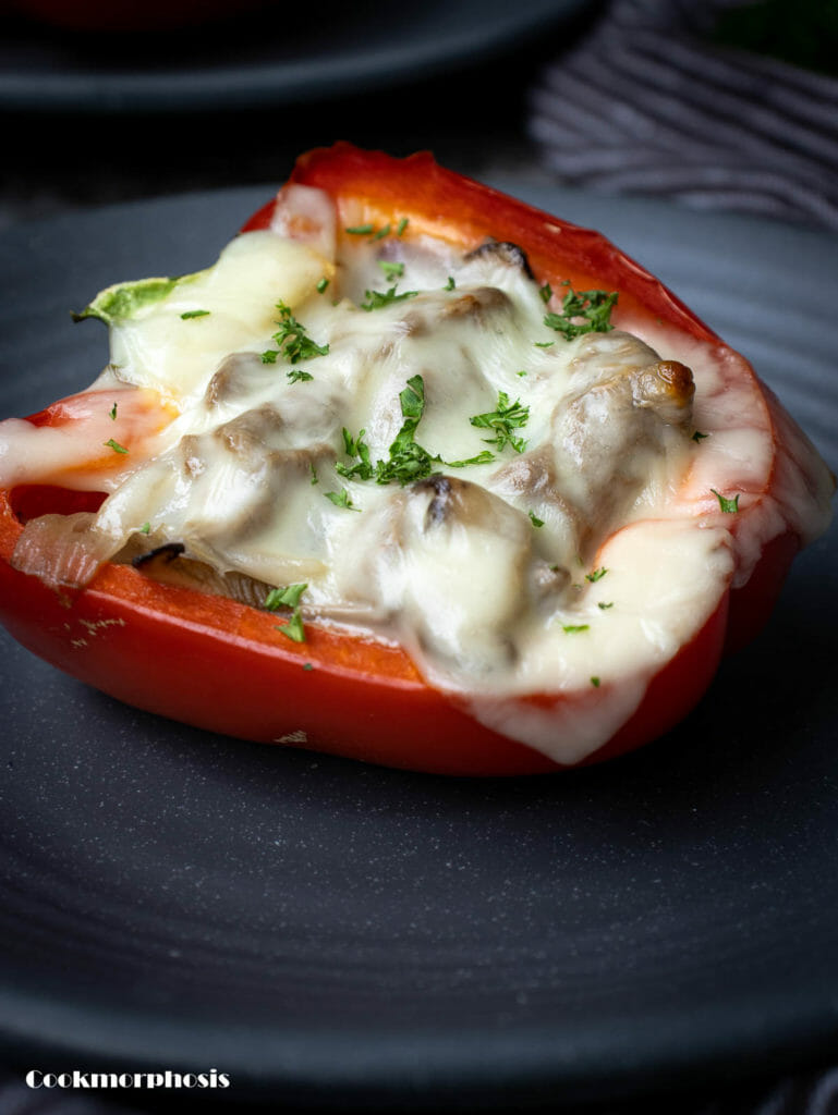 a quick dinner recipe: a half fusion garlic cajun philly cheesesteak stuffed pepper put on a grey plate
