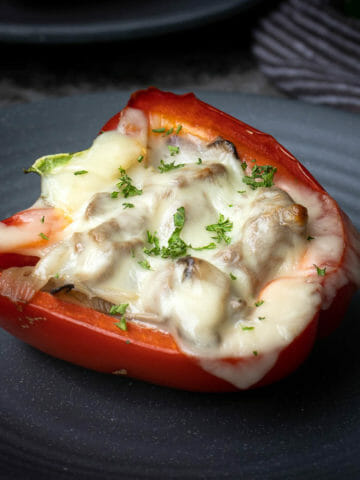 Cajun cheesesteak stuffed peppers put on a grey plate, a 30 minutes ready recipe