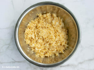 toss cooked rice with beaten egg and soy sauce in the mixing bowl