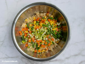 add frozen veggies, green onion, garlic, ginger to the rice mixture