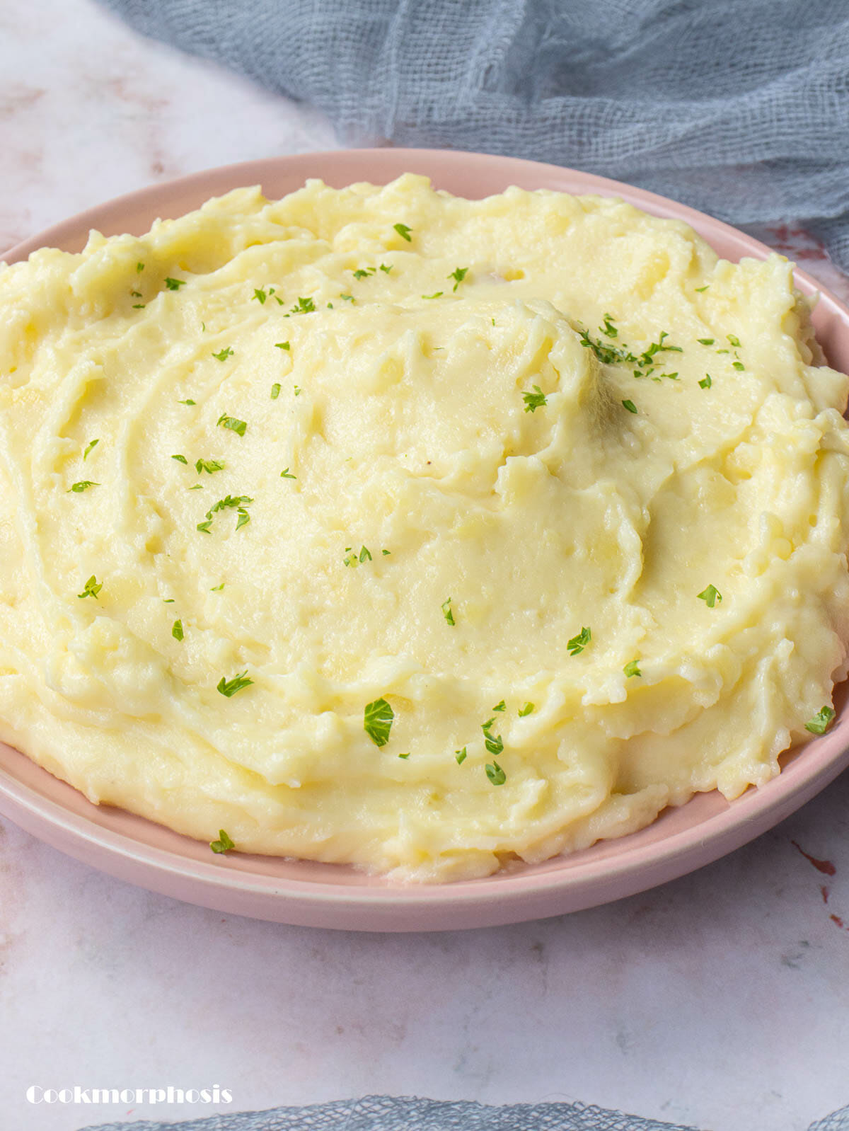 a plate of mashed potatoes garnished with chopped parsley