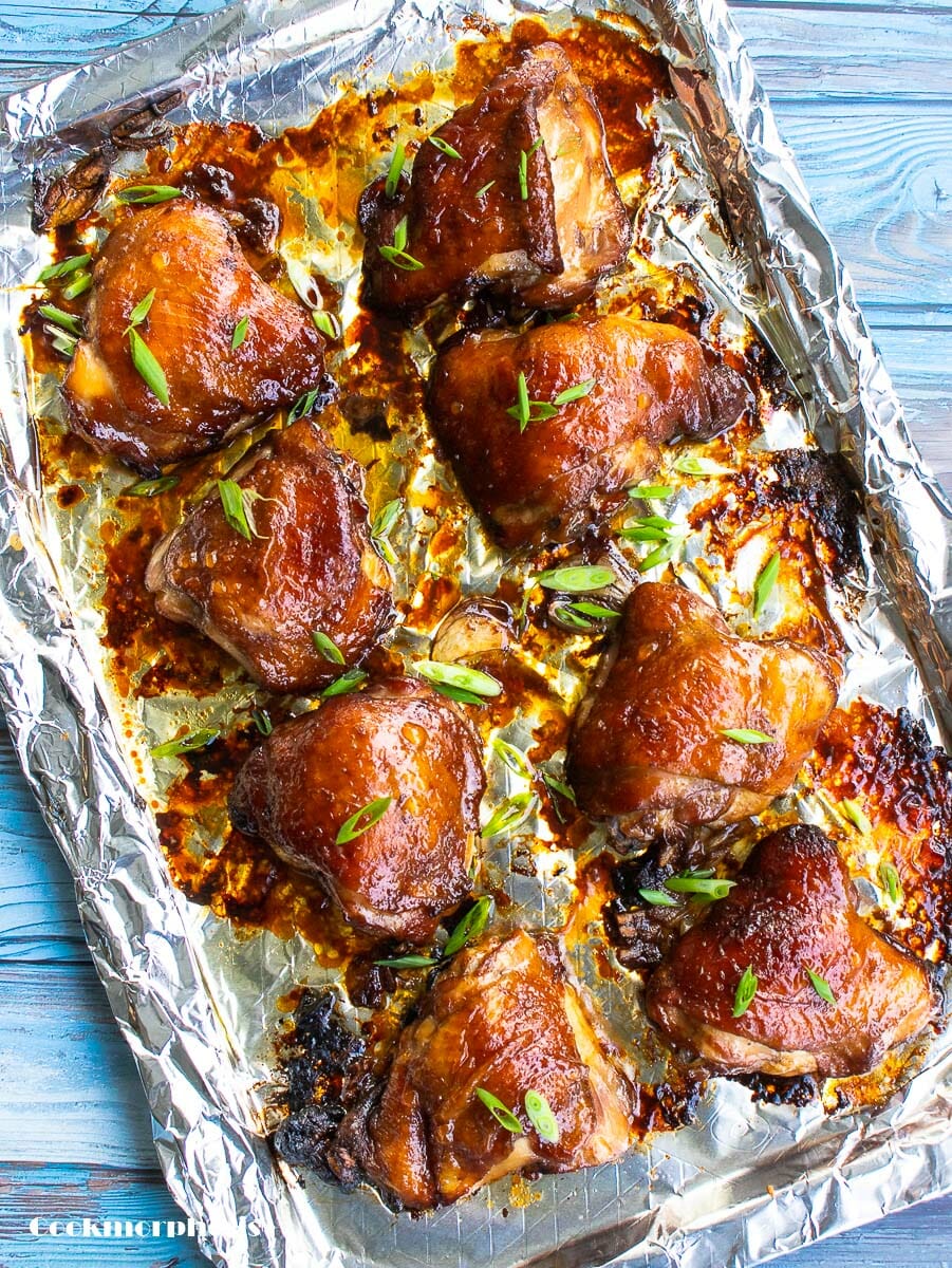 8 chicken thighs baked in soy sauce (asian style) put on a rimmed baking sheet lined with aluminum foil