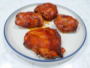 4 pieces of baked chicken thighs with sriracha and lee kum kee char siu sauce