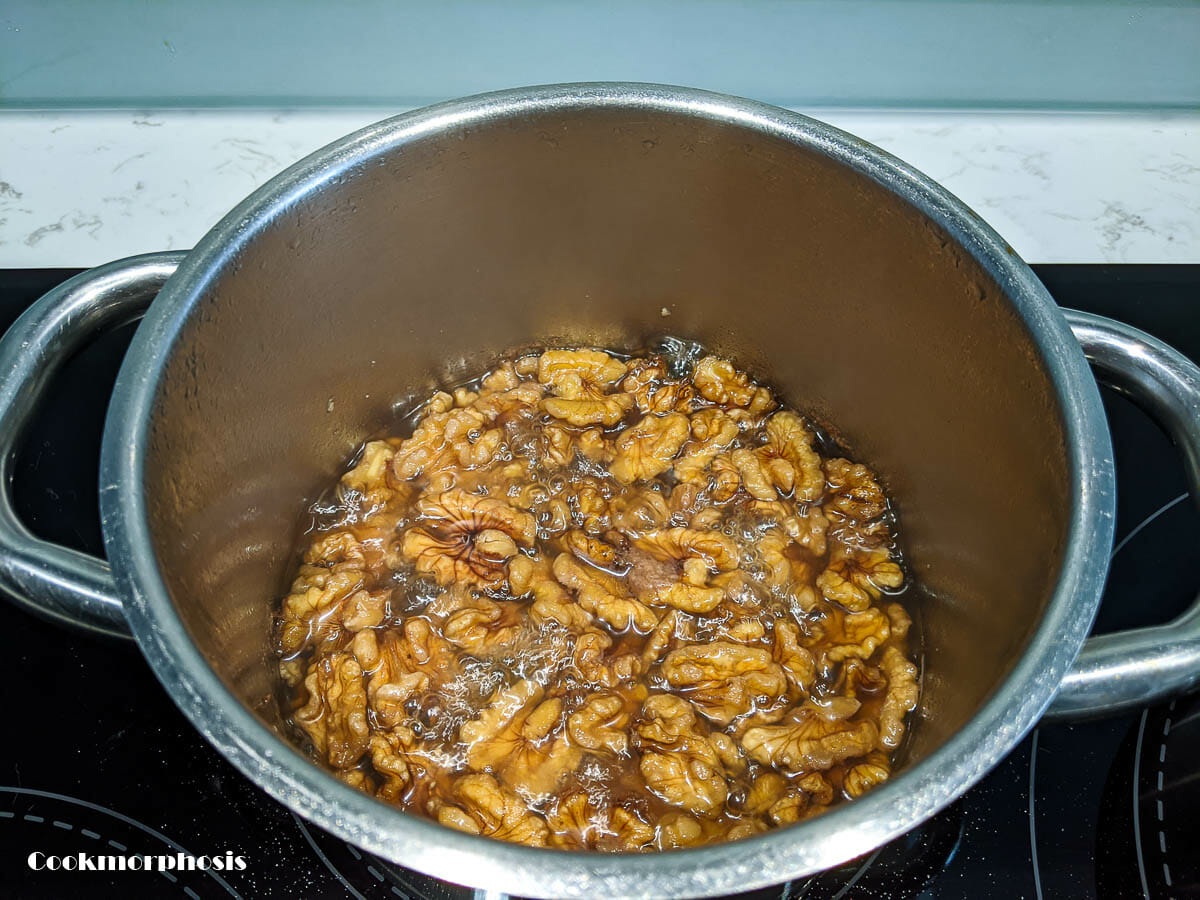 cooking walnuts in sugar mixture to caramelize them