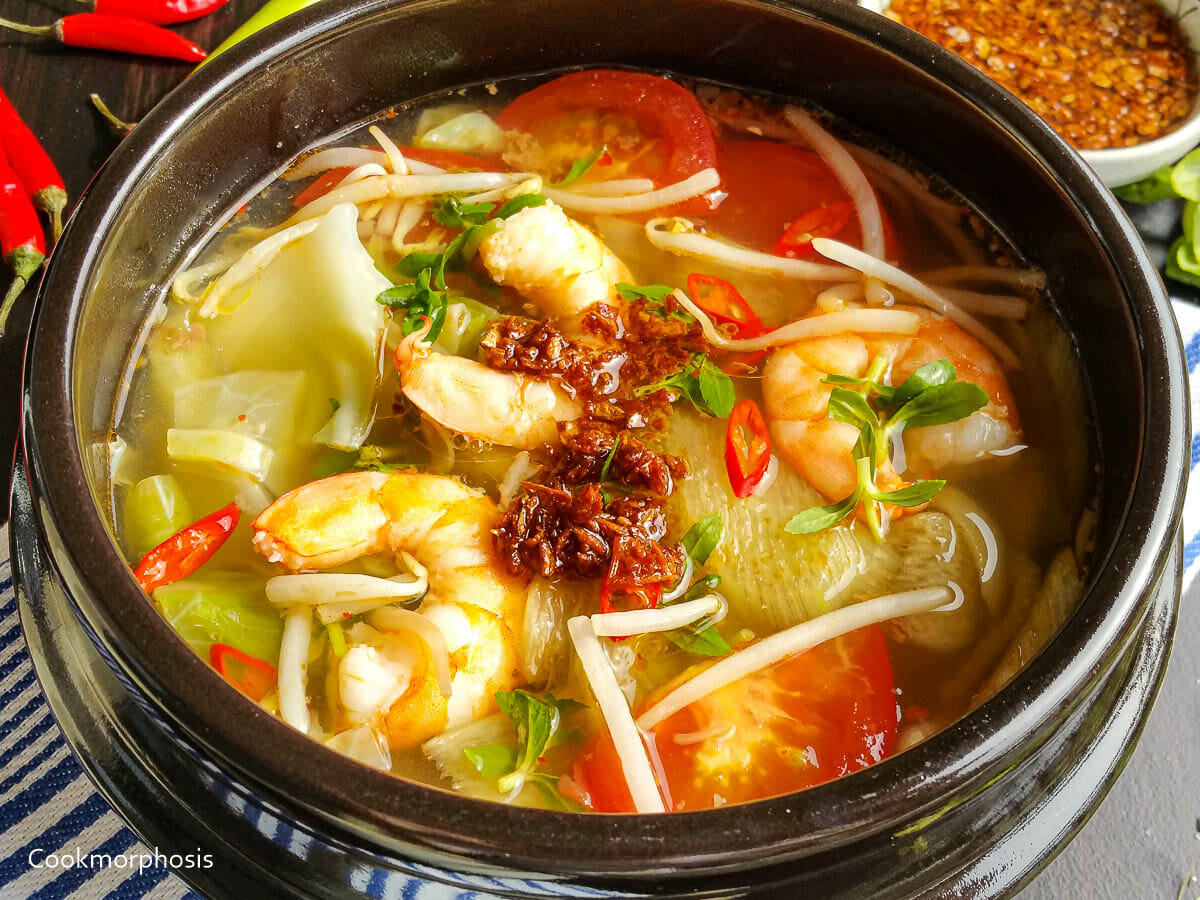 Vietnamese hot and sour shrimp soup made with shrimp, tomato, bean sprout, rice paddy herb
