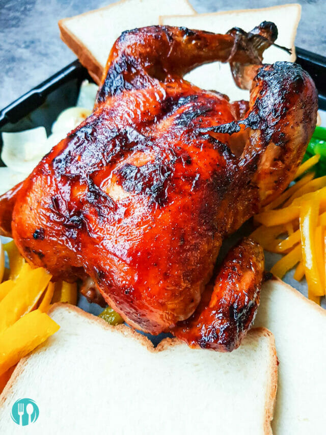 a close up look of a roasted chicken with a few charred spots on its skin