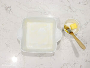 grease baking pan with soften butter