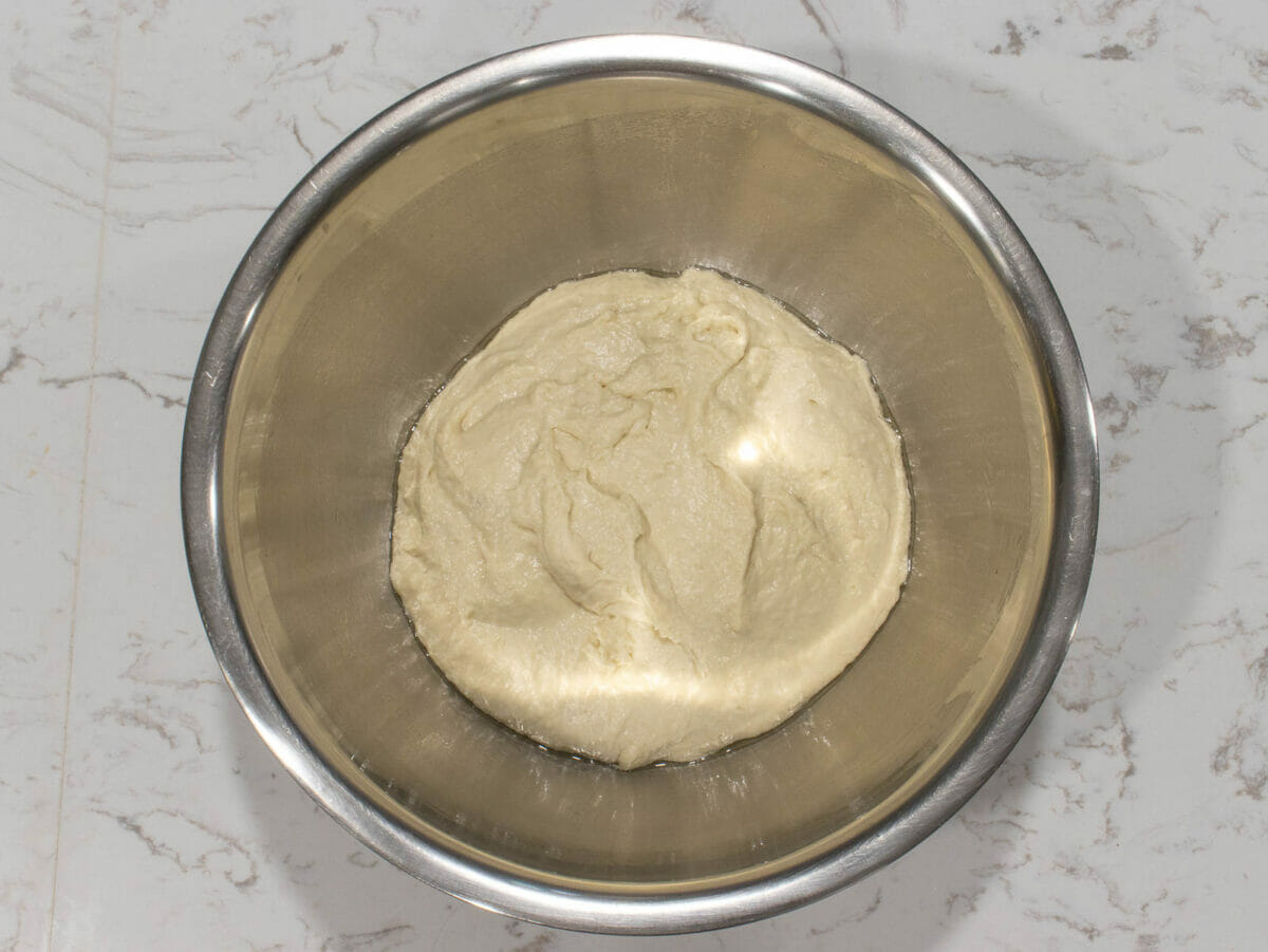 ferment ciabatta bread dough in a large mixing bowl