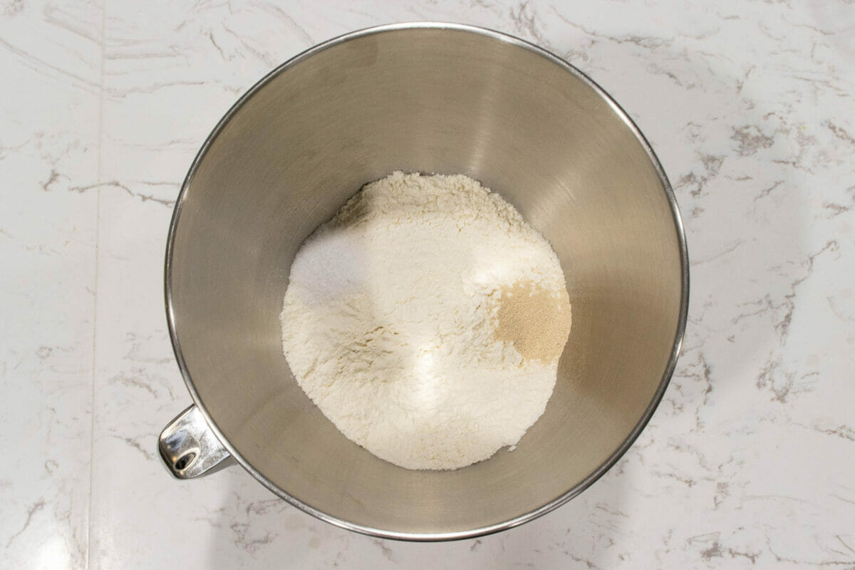 flour, yeast and salt are added in a mixing bowl