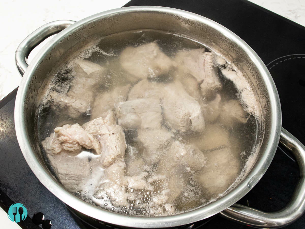 blanching pork ribs in a cooking pot