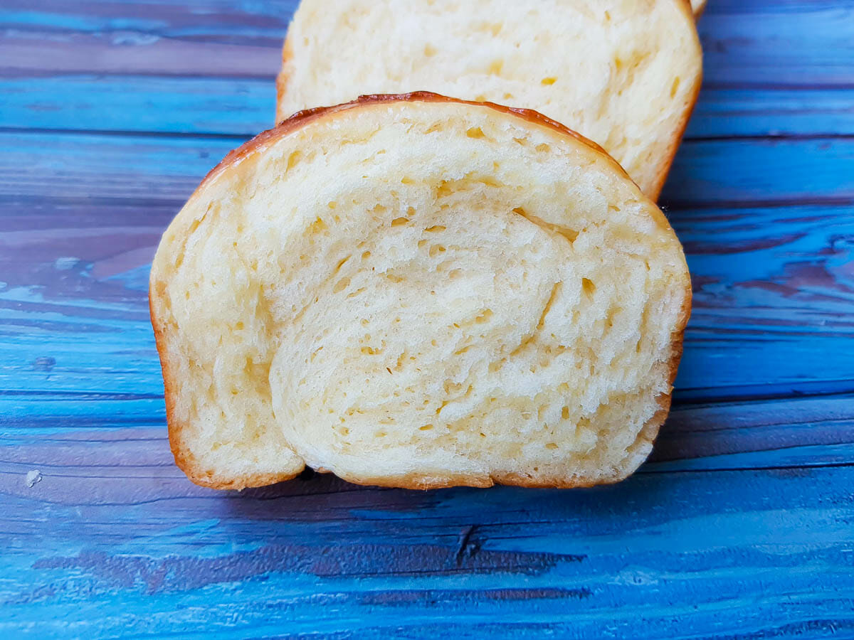 a slice of super soft bread made glazed with sweetened condensed milk