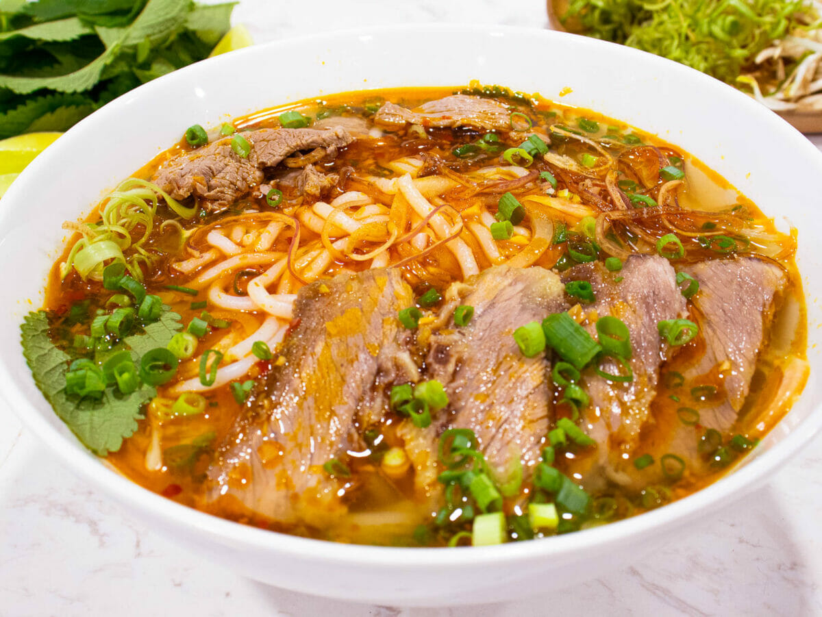 a bowl of vietnamese spicy beef noodle soup