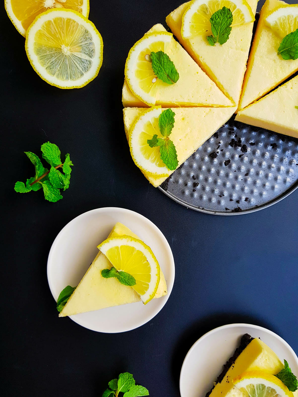7 slices of lemon cake garnished with mint leaves and lemon slices