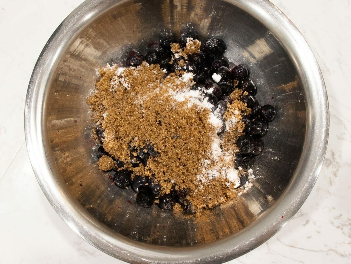 a bowl of blueberry mixture with cinnamon spice and sugar