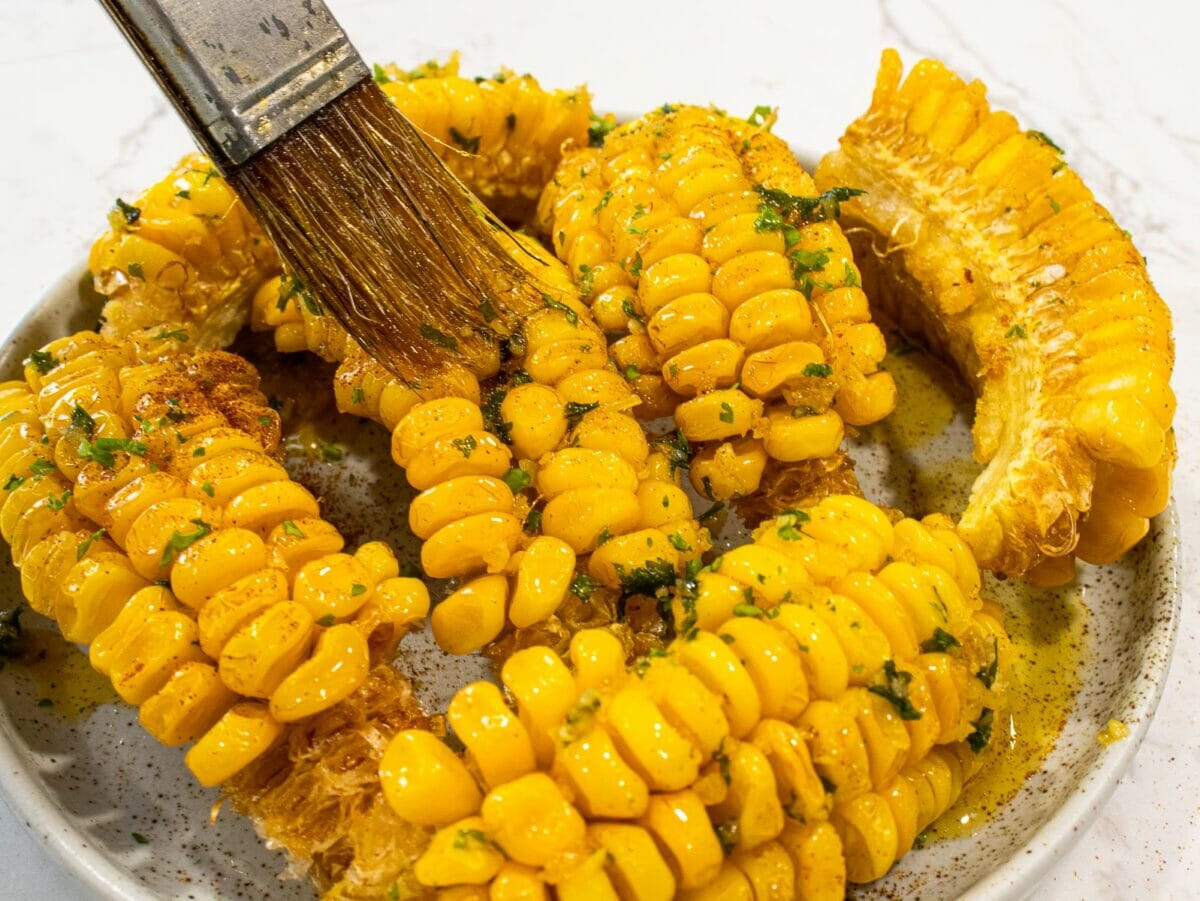 brush corn on the cobs with garlic butter mixture
