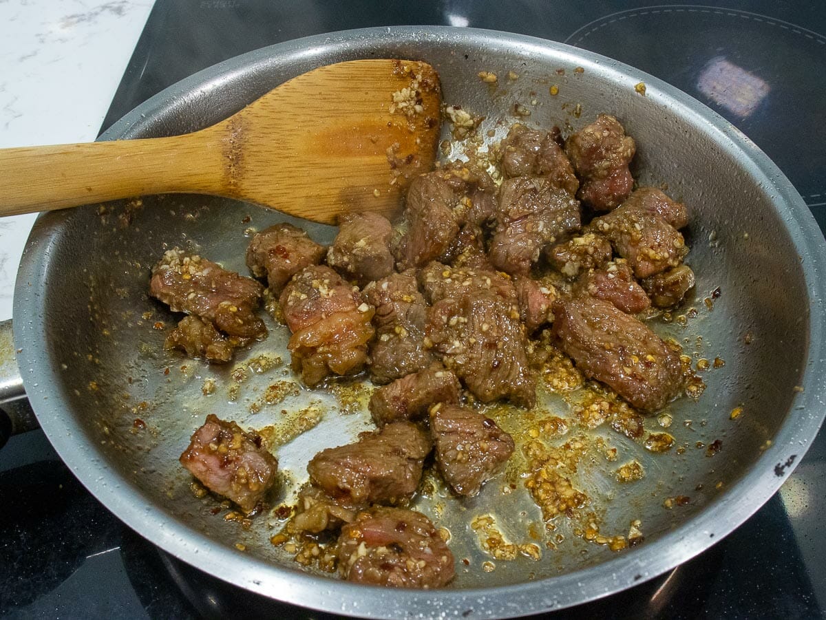 sauté marinated beef on a hot skillet