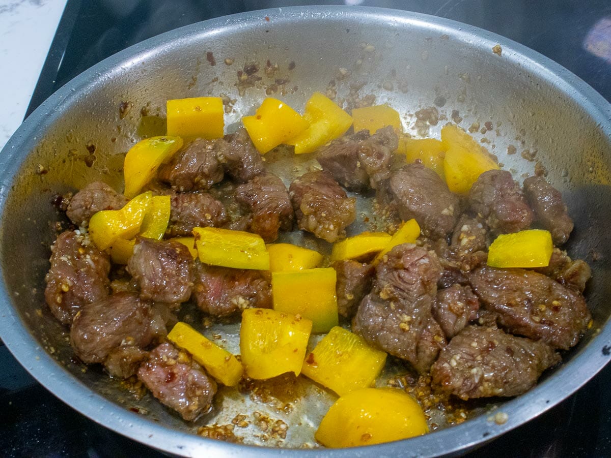 Add bell pepper to saute beef