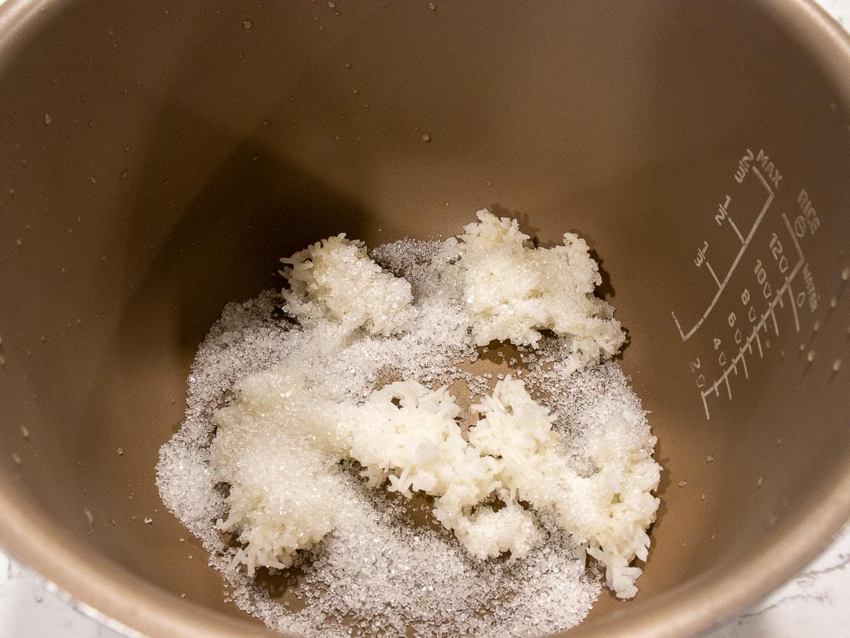 put cooked rice and sugar in a rice cooker