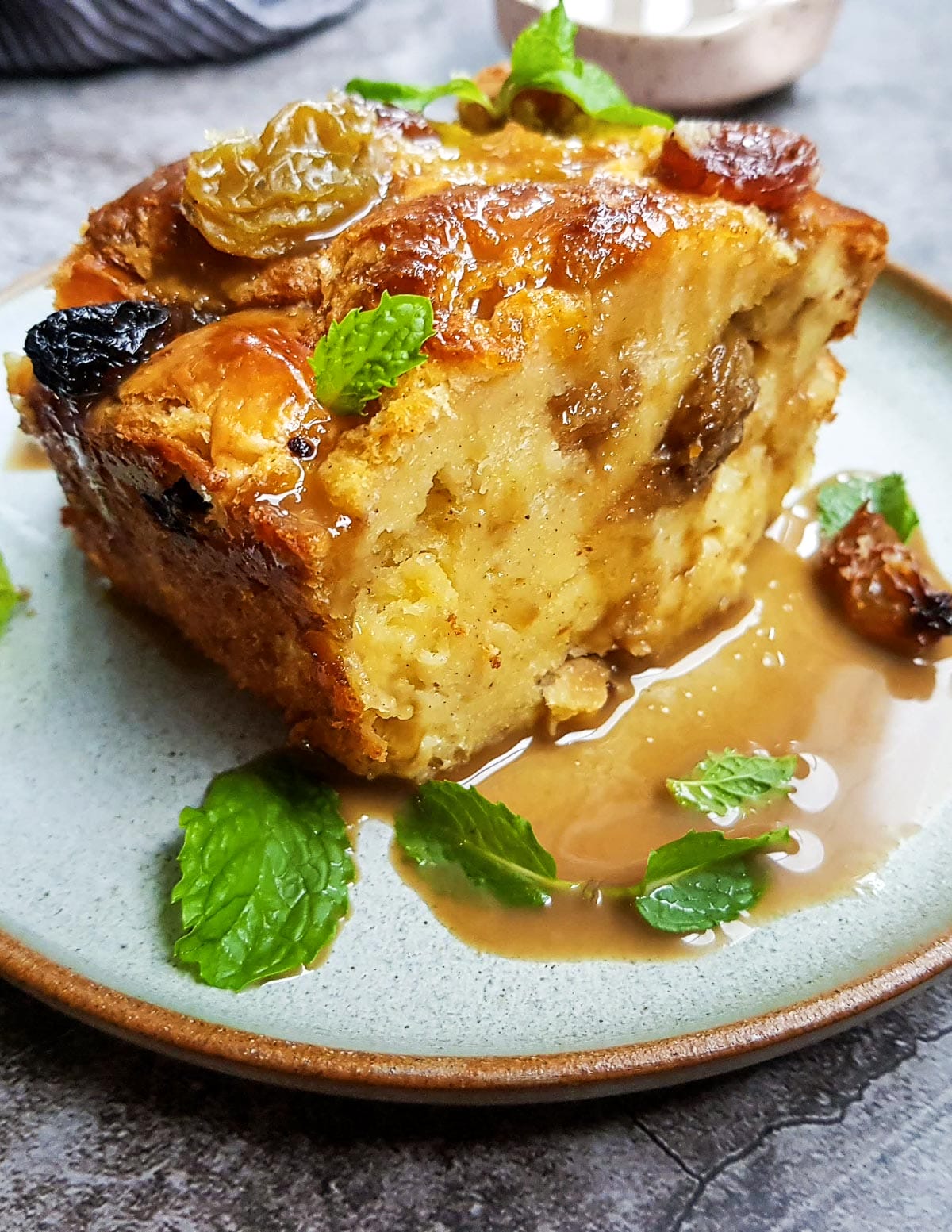 a big slice of raisin bread pudding with coffee sauce