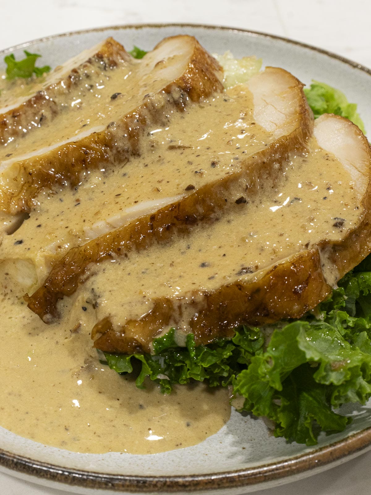 3 slices of turkey breast covered in creamy pepper gravy