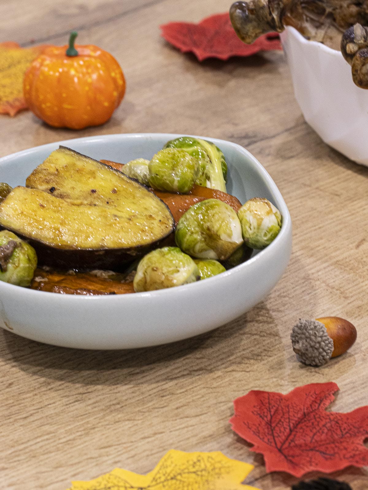 a plate of roasted vegetables included sweet potato, carrot and brussels sprouts