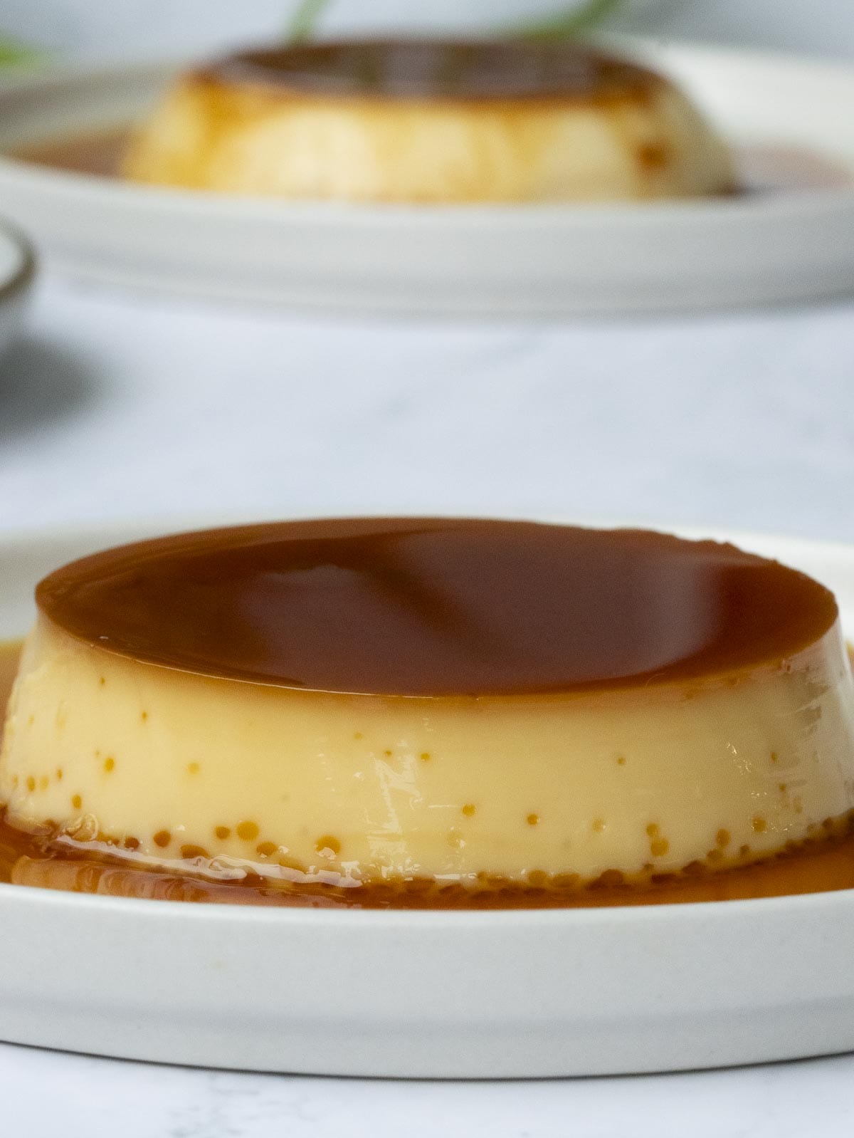 a close up of a creamy caramel flan