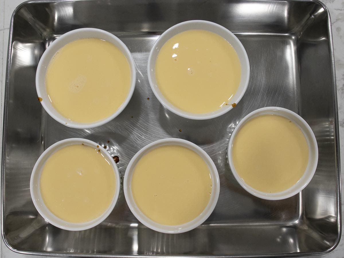 egg custard is pour into each ramekin