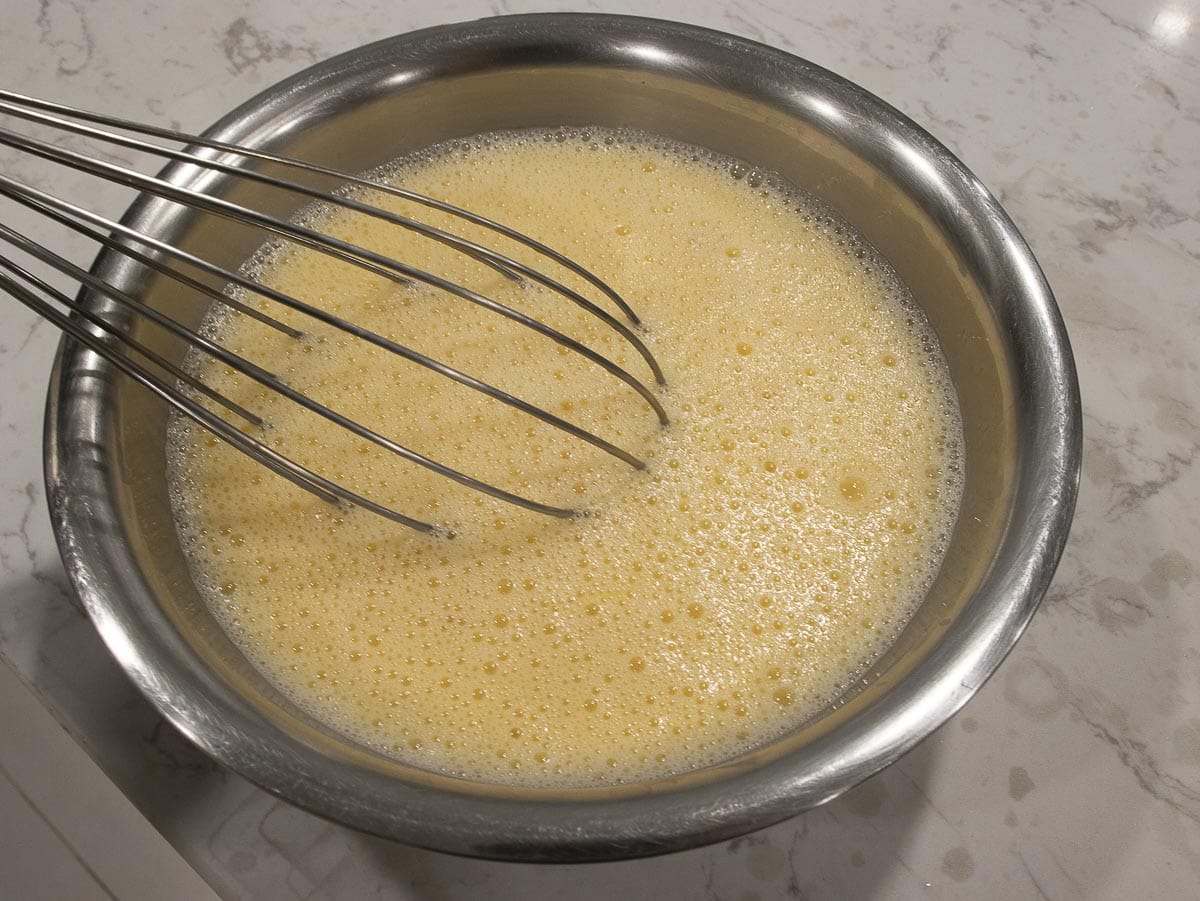 add egg mixture into a condensed milk mixture in a mixing bowl