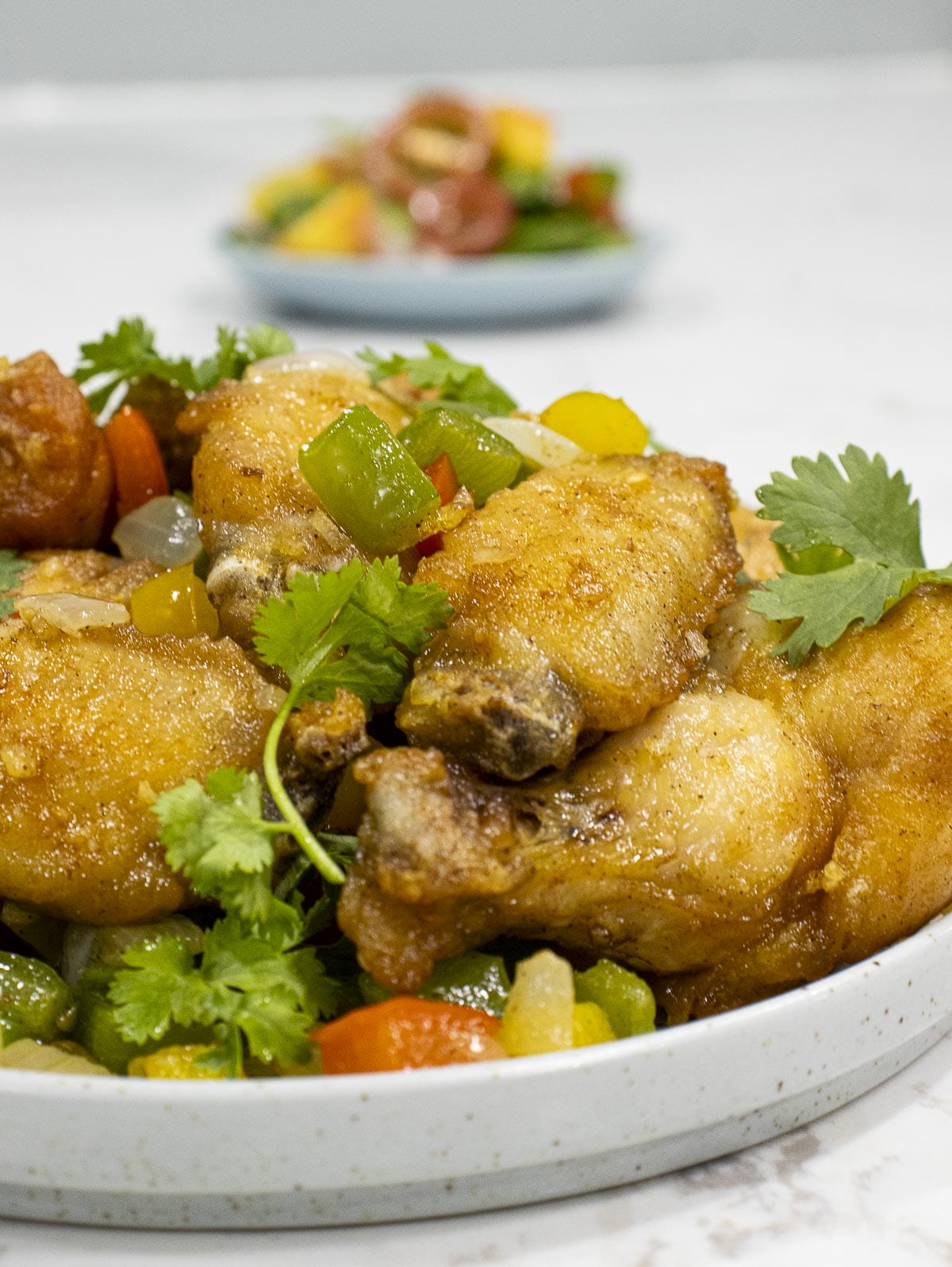 fried salt & pepper chicken wings with white onion and bell pepper