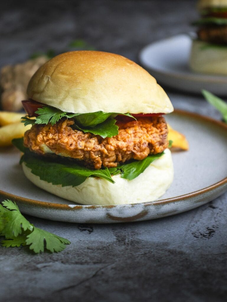 a crispy chicken pho burger put on a white plate