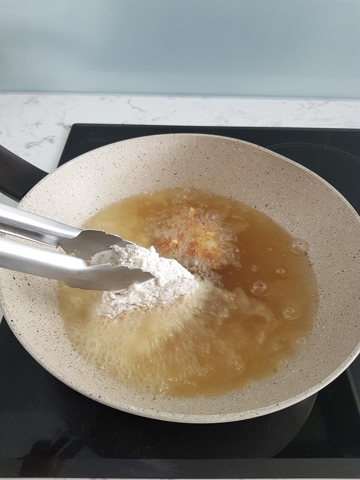 add second piece of fried chicken cutlet into the pan