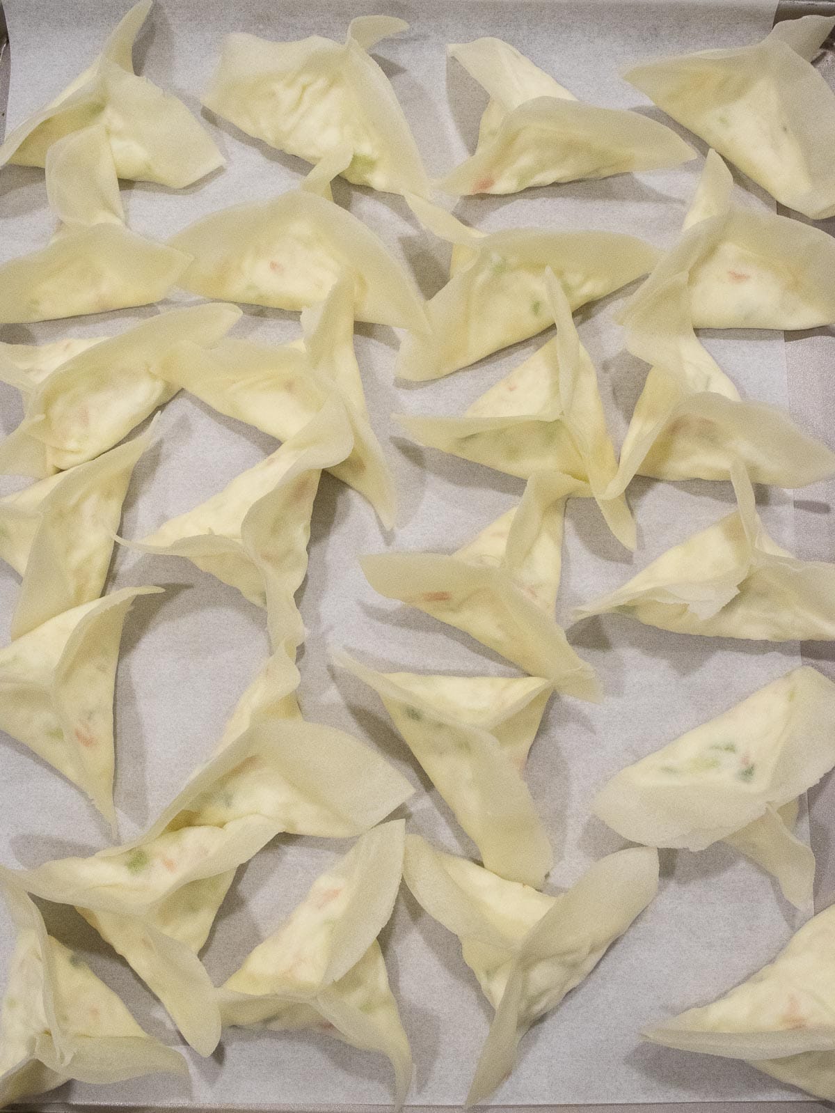 a pan of uncooked crab rangoons