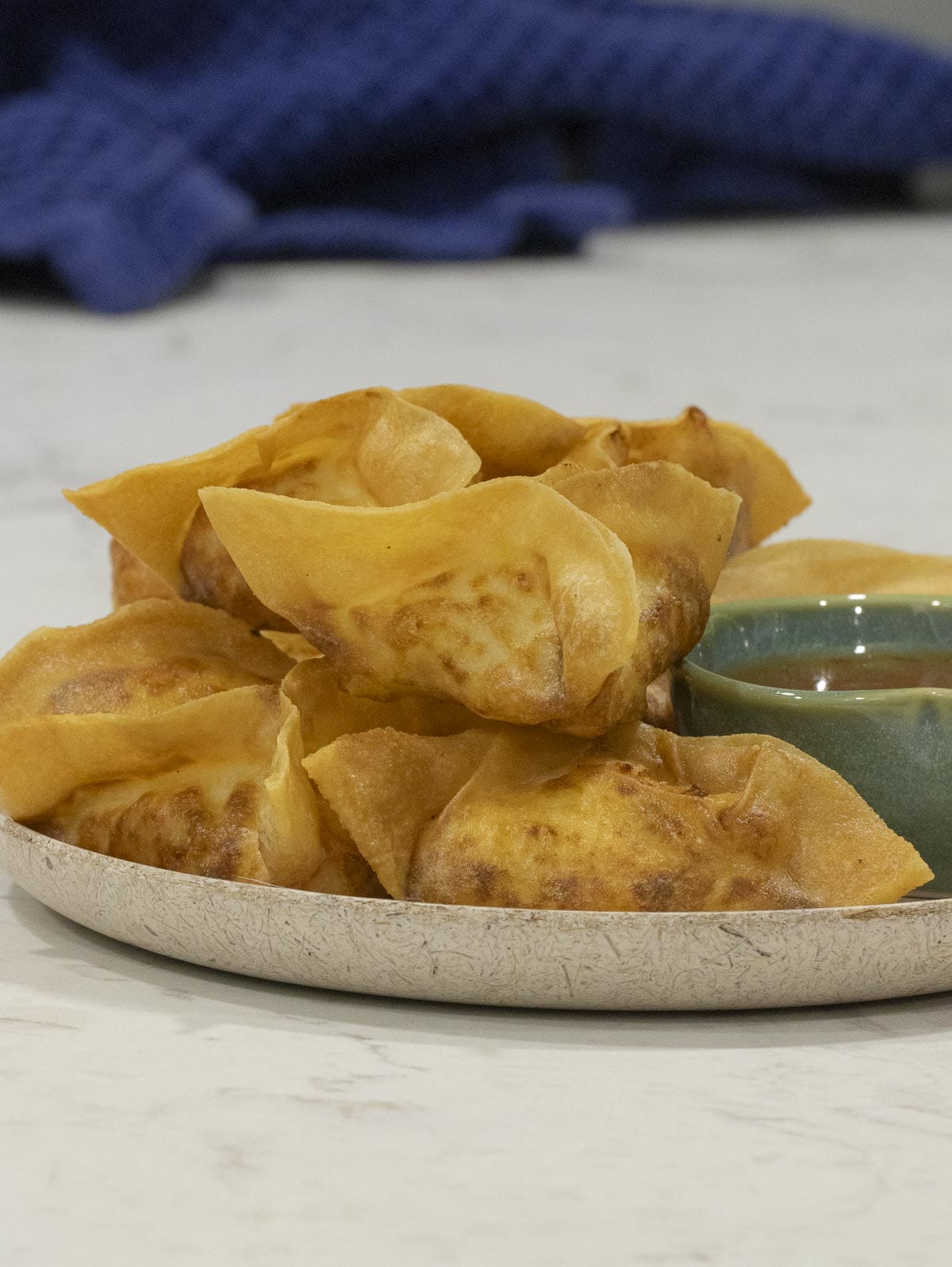 fried rangoons put on a white plate