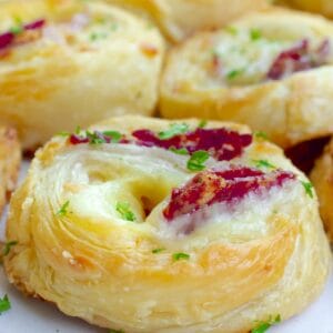 a pepperoni pizza pinwheel garnished with chopped parsley